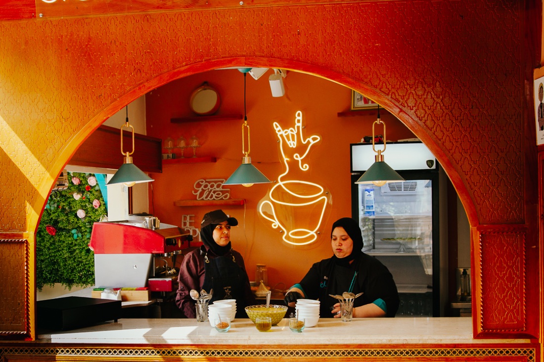 Two women behind the counter of Amal's Sign Language Café